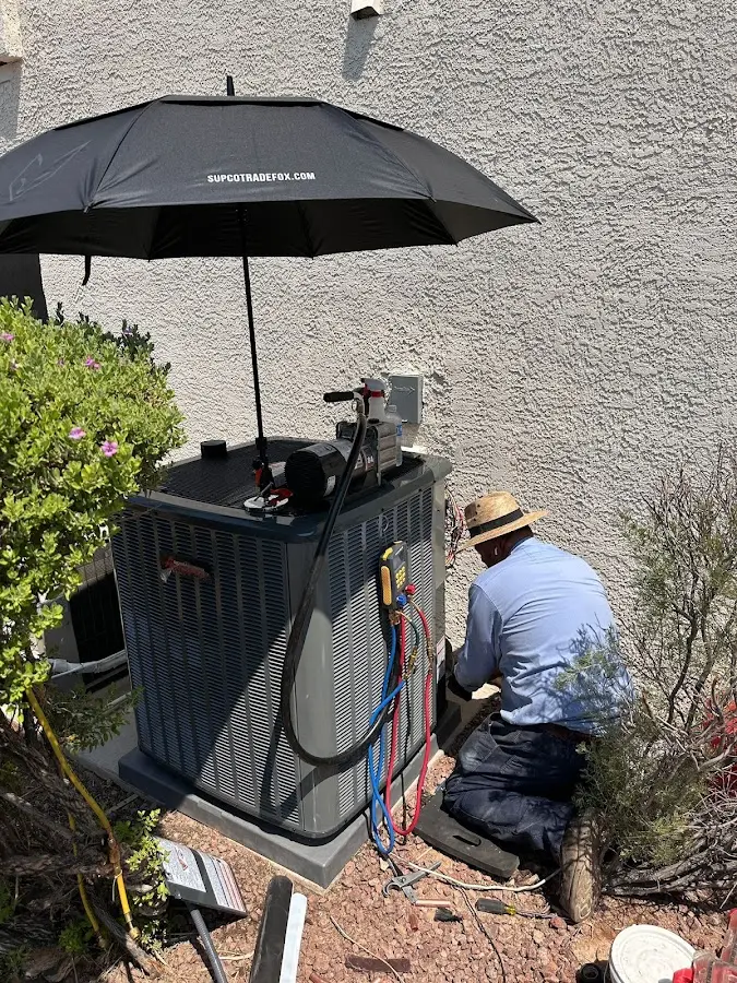 HVAC technician performing outdoor AC maintenance in Olyphant